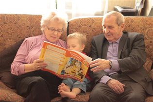 бабушка и дедушка читают внуку